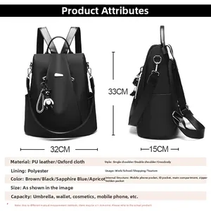 Detail view of black oxford backpack with bear charm and size specs 33x32x15cm