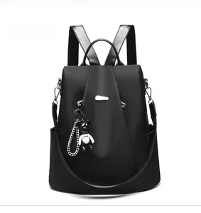 Front view of a black oxford fabric women backpack with a cute panda pendant