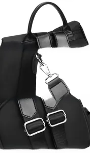 Detail of durable top handle, metal hooks, and adjustable straps on black nylon backpack