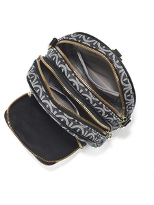 Chic shoulder bag with three gold zippers and black-white geometric patterns on white background
