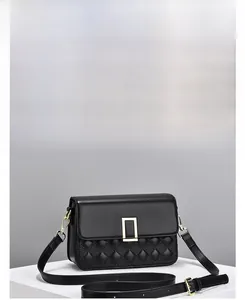 Detailed view of black quilted shoulder bag with golden buckle and sleek PU leather texture