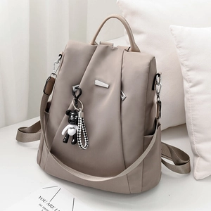 Khaki nylon backpack for women with bear charm and silver metal geometric accents