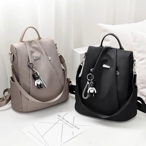 Women's Oxford cloth backpack in khaki and black with cute bear charms and side pockets