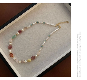 Detailed shot of handmade colorful gemstone necklace with gold adjustable chain