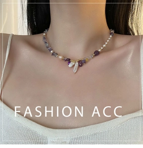 Detail of freshwater baroque pearl and amethyst beaded necklace worn on neck