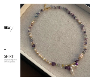 Detail of amethyst and baroque pearl necklace with gold-plated lobster clasp and chain