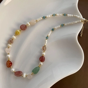 Bohemian natural stone necklace with freshwater pearls and gold beads in shell dish