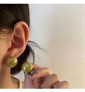 Macro detail of olive green round studs with vintage translucent cloud texture