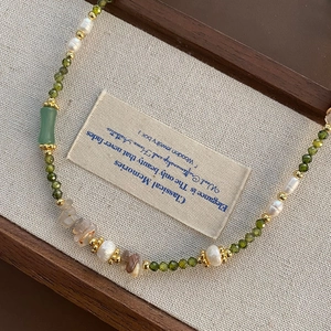 Vintage green beaded necklace with white pearls and jade pendant in wooden jewelry box