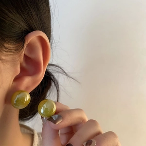 French retro style titanium steel earrings with large round textured green resin pearls