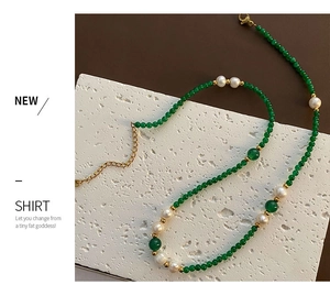 Close-up of green agate and pearl necklace with adjustable gold-plated lobster clasp