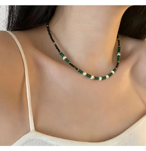 Macro shot of new Chinese style agate and pearl necklace with golden spacers on neck