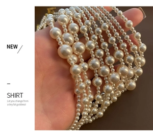 Detail of layered cream pearl necklace with gold clasp made of durable titanium steel