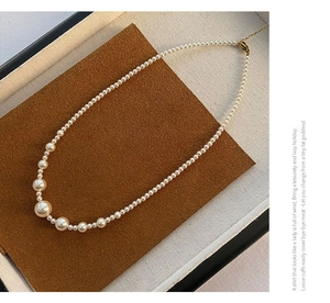 Detailed view of high-lustre mermaid pearl necklace with gold-plated titanium steel clasp