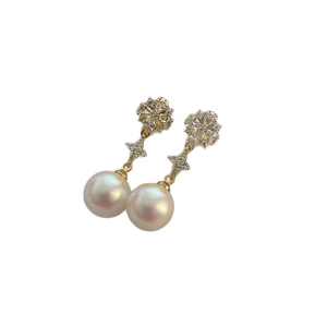 Elegant gold drop earrings with large white pearls and sparkling diamond floral accents
