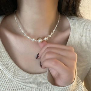 Elegant white gradient pearl necklace in titanium steel on female neck