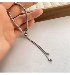 Close-up of adjustable silver stainless steel snake chain bracelet with sliding ball clasp