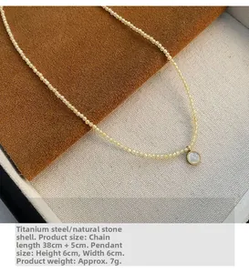 Detail view of titanium steel necklace with natural stones and a 6cm shell pendant