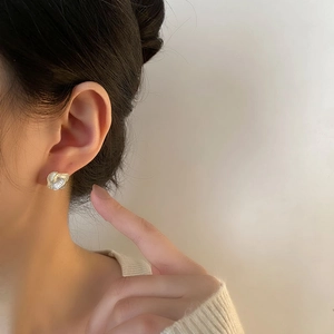 Elegant camellia flower stud earrings with gold trim on model for a minimalist look