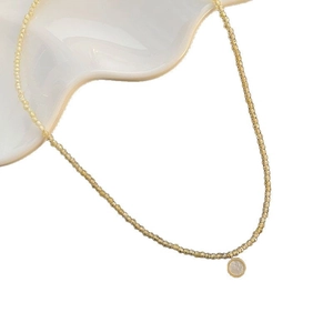 Champagne gold micro-beaded necklace with a round white mother of pearl pendant
