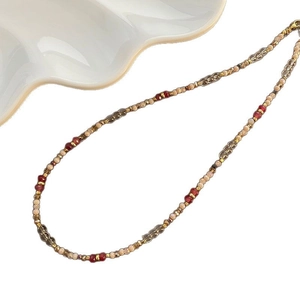 Elegant beaded necklace with deep red and champagne gold beads in vintage style