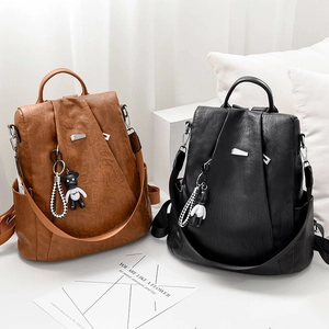 Chic women's Oxford backpack in brown and black with bear pendant and check strap
