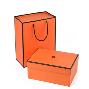 Elegant bright orange gift box and matching carrier bag with black border and greeting text