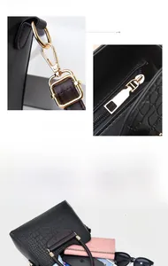 Detailed macro view of black crocodile pattern PU leather handbag with gold metal hardware