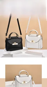Detail of woven side panels and metal twist lock on black and white handbags