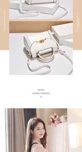 Detail of white leather handbag featuring golden ring lock and arched metal handle