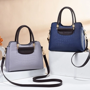 Elegant crocodile-embossed handbags in purple and blue with crossbody straps