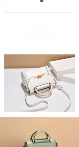 Detail showing white and pale green leather bags with metal handles and woven side trim