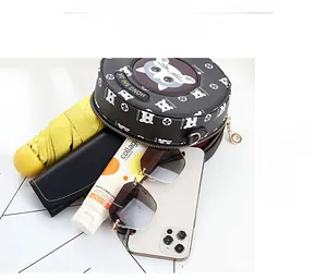 Top view of round cat print crossbody bag showing large capacity for umbrella and phone
