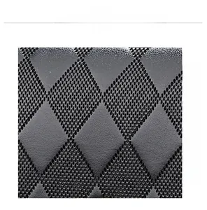 Macro shot of black leather handbag featuring quilted diamond pattern and micro-dotted texture