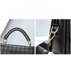 Detail of woven metal handle and detachable shoulder strap on black quilted handbag