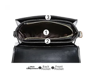 Interior detail of black PU leather bag showing three main compartments with gold zippers