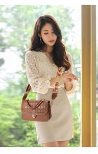 Detail of brown quilted leather crossbody bag with gold twist lock and woven strap