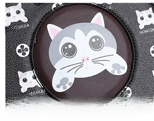 Macro shot of black lychee grain leather with cute cartoon cat print and branding detail