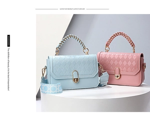 Detail of chic diamond-quilted PU leather handbag with gold twist lock and woven chain