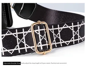 Detailed macro view of adjustable black and white grid nylon strap with gold alloy buckle