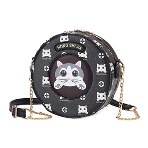 Black round cat-themed crossbody bag with gold chain strap and textured leather finish