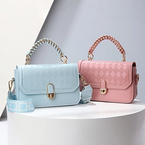 Quilted crossbody bag with metallic handle and wide strap in blue and pink