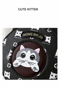 Detailed macro view of litchi textured leather with cartoon cat print and gold embroidery