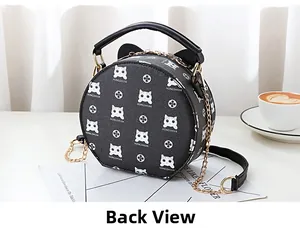 Detail view of the back of this circular black crossbody bag with cat monogram pattern