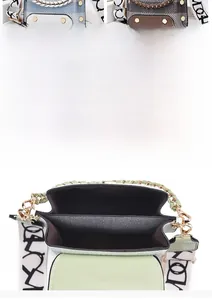 Detail view showing dual main compartments of a stylish crossbody bag with broad strap