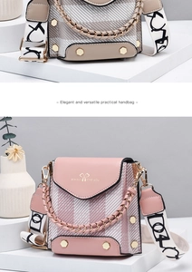 Detail of crossbody bag featuring pink plaid fabric and elegant gold metal handle