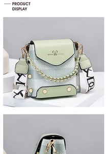 Detail of mint green crossbody phone bag featuring a gold chain and woven patterned strap