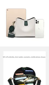 Internal storage detail of green and white crossbody bag showing multi-compartment capacity
