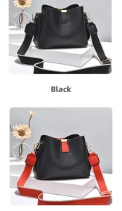Detail of black lychee grain leather bucket bag with two interchangeable woven straps