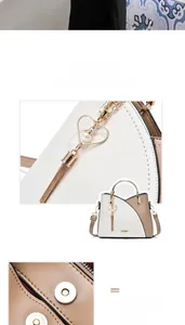 Detail of magnetic snap closure and heart-shaped tassel charm with pearl on ladies handbag